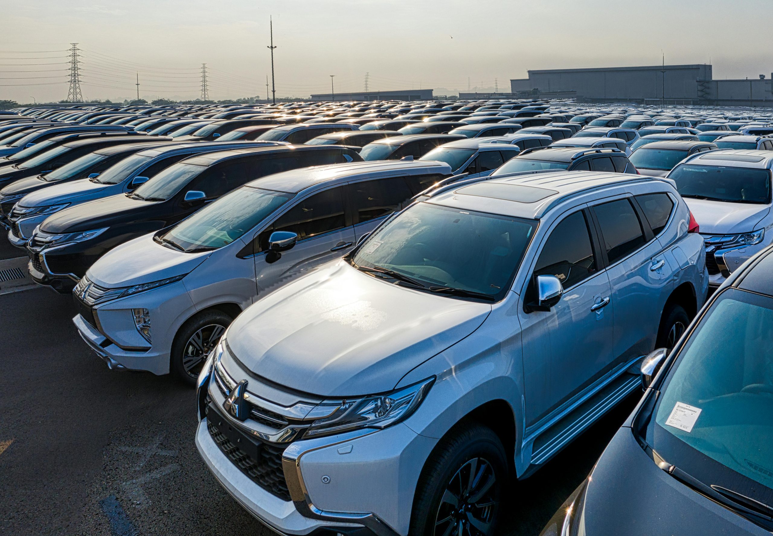 Home Modern prestige shiny cars in rows on asphalt parking of contemporary manufacture in daytime